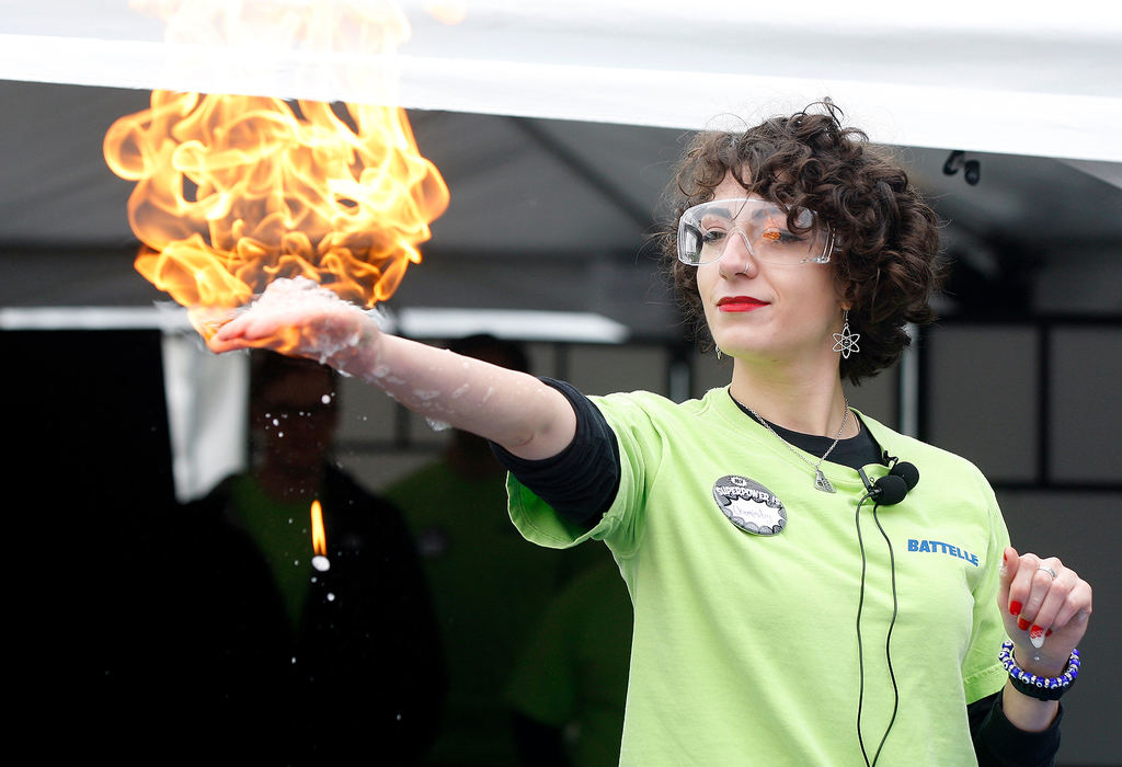 Portrait - 3rd placeLindsey Sequeira, Battelle associate researcher and analytical chemist, has methane bubbles ignited in her hand for the crowd to see during the "Big Science Celebration" hands-on event to close out the inaugural COSI Science Festival in Columbus. (Shane Flanigan/ThisWeek Community News)