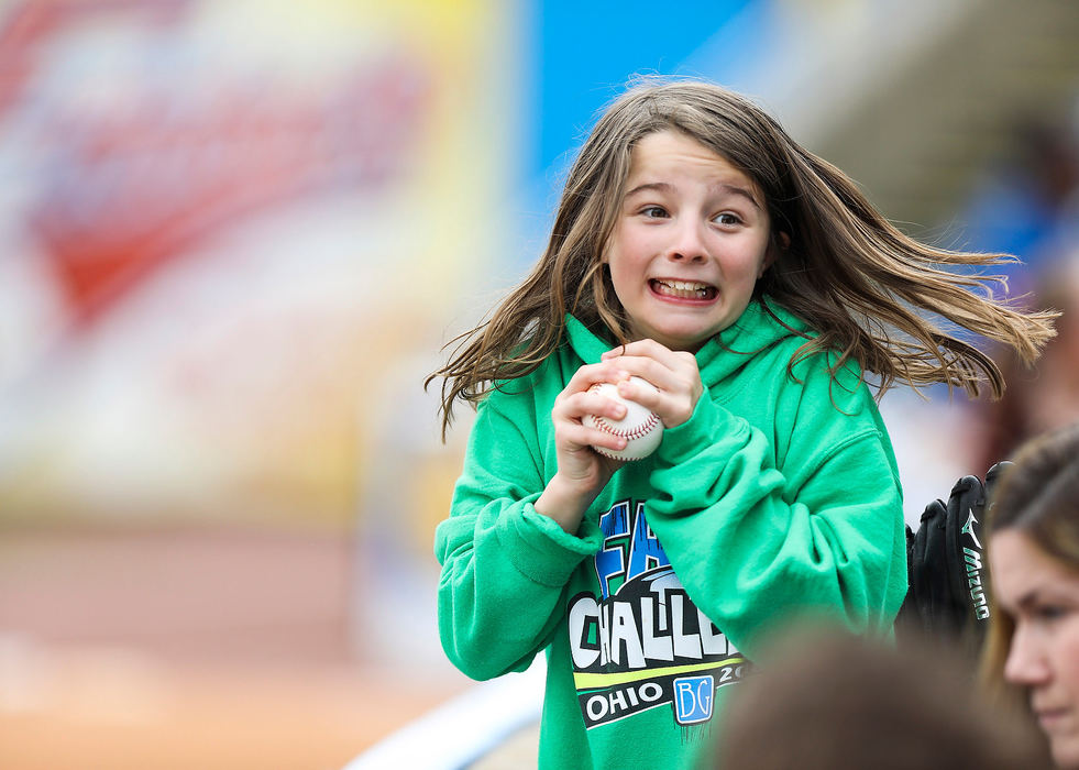 Sports Feature - 2nd placeKaylee Potrzebowski, 9, smiles after getting a foul ball as the Toledo Mud Hens host the Louisville Bats during a baseball game at Fifth Third Field in Toledo. (Rebecca Benson/The Blade)