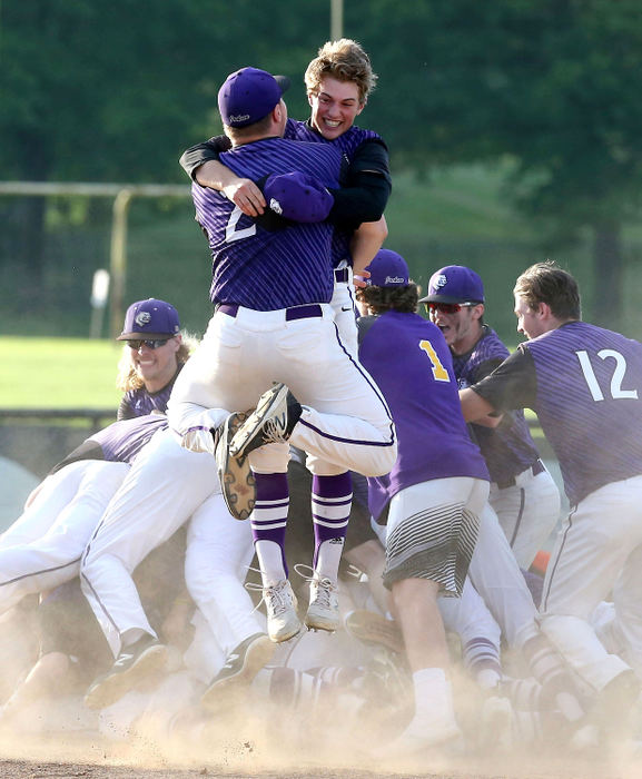 Sports Feature - HMJackson's Matt Hicks (back to camera) and Ethan Kulich celebrate with their teammates after defeating Hoover 4-3 in eight innings in the Div. I district championship game in North Canton. (Scott Heckel/The Canton Repository)