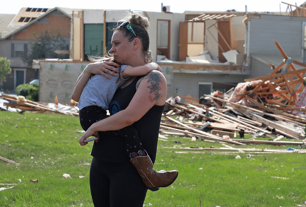 Spot News - 1st placeMay - First Place Spot News Meghan Porter holds her frightened daughter, Gemma, 6, as they walk through their destroyed Beavercreek neighborhood. A series of overnight tornados destroyed hundreds of homes in the Dayton and surrounding areas.  (Bill Lackey/Springfield News-Sun)