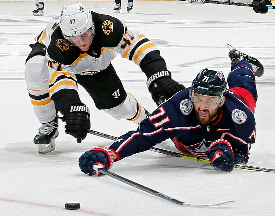 Sports - 2nd placeColumbus Blue Jackets left wing Nick Foligno (right) dives to shoot the puck against Boston Bruins defenseman Torey Krug  during the third period in Game 3 of the NHL Stanley Cup Playoffs Eastern Conference semifinals at Nationwide Arena in Columbus. (Kyle Robertson/The Columbus Dispatch)