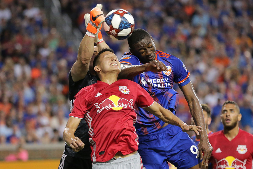 Sports - 3rd placeFC Cincinnati forward Fanendo Adi (9) goes for a header on goal in the second half of an MLS soccer match against the New York Red Bulls at Nippert Stadium in Cincinnati. New York Red Bulls won 2-0. (Kareem Elgazzar/The Cincinnati Enquirer)