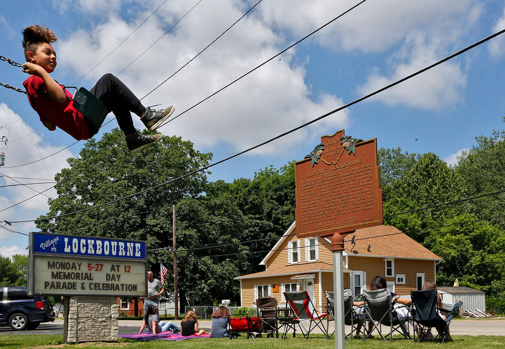 Story - 2nd placeAires Holland of Columbus swings in the community park while waiting the start of the Lockbourne Memorial Day Parade in southern Franklin County.  (Eric Albrecht/The Columbus Dispatch)