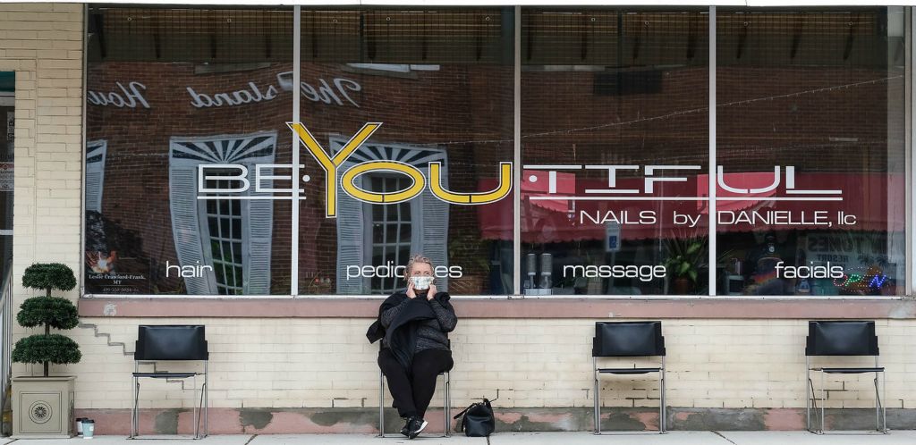 General News - 2nd place - Rainy Studer of Port Clinton covers her face with a protective mask while waiting for her hair color to process outside of the BeYoutiful Hair Salon on Madison Street in Port Clinton. Studer wanted to wait outside to enjoy the outdoors, social distance  and watch people enjoy outdoor dining. Salons are now open for business as Ohio begins loosen restrictions amid the coronavirus pandemic.  (Jeremy Wadsworth / The Blade)