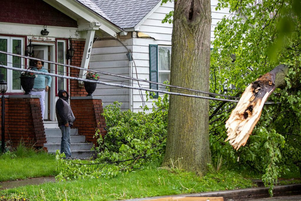 Spot News - 2nd place - Karen DeValt (left) and her son Anttwon Cheeves look at the damage from a tree that fell on wires in Karen's front yard on Mettler Street in Toledo. Anttwon said his mother had called someone last week over concerns of the tree in her front yard.  (Rebecca Benson / The Blade)