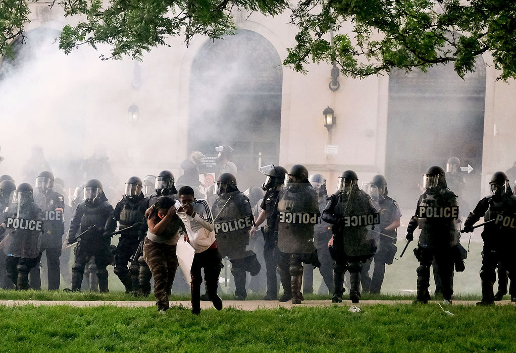 Story - 2nd place - Two people scatter as police deploy tear gas near the Lucas County Courthouse grounds during a protest in Toledo. People gathered in and around downtown Saturday night to protest the killing of George Floyd in Minneapolis.  (Kurt Steiss / The Blade)