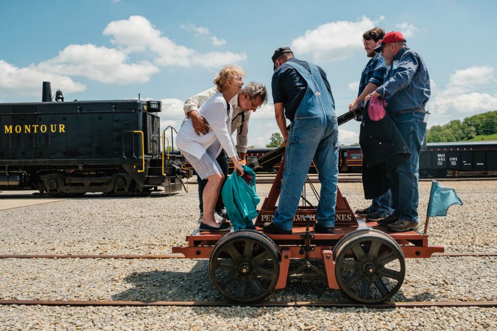 Feature - 2nd place - Tour participants operate a Pennsylvania Lines 106 Hand Car during one of two Blue Flag tours open to the public at the Age of Steam Roundhouse and Museum in Sugarcreek.  (Andrew Dolph - The Times Reporter)  