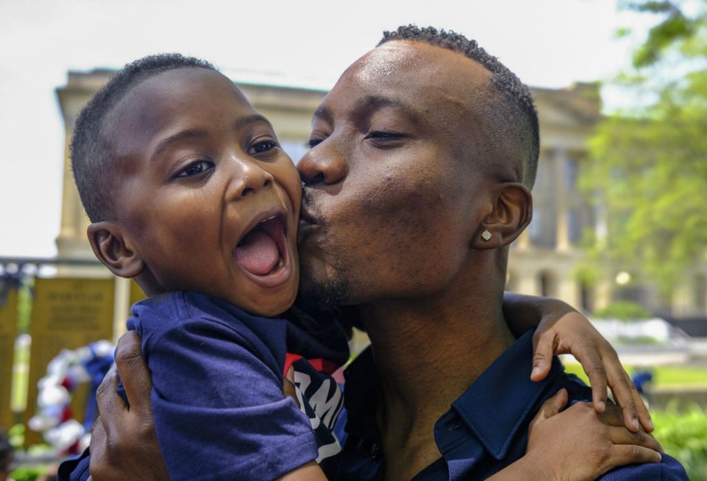 General News - 2nd place - Olatunji Muyideen Yusuff, originally from Nigeria, kisses his son Wareez, 4, after becoming a US citizen during a Naturalization Ceremony Thursday, May 19, 2022, at the Civic Center Mall in Toledo.  (Jeremy Wadsworth - The Blade)  