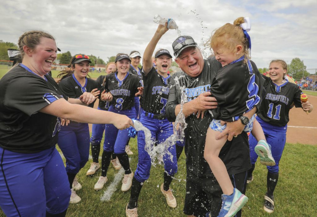 Sports Feature - 1st place - Springfield head coach Rob Gwozdz and his granddaughter Hallee Hall, 4, are doused with water after the Blue Devils defeated  Anthony Wayne, 5-4, during an OHSAA Division I regional semifinal softball game at Gibsonburg High School in Gibsonburg.   (Jeremy Wadsworth - The Blade)  