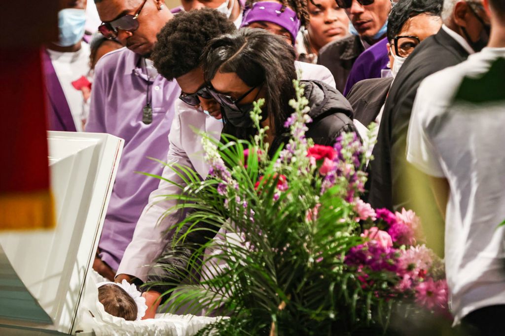 Story - 1st place - Jeremiah Hughes (left) and Gloria Cowell say goodbye to their daughter during the funeral for 7-month-old Desire Hughes at Warren AME Church in Toledo. Desire was killed in a drive-by shooting while in the car with her Dad last week.  (Rebecca Benson - The Blade)  