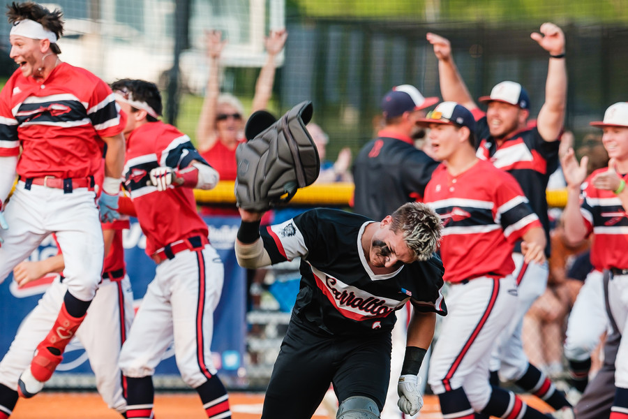 Sports Feature - HM - Indian Valley celebrates their win over Carrollton as catcher Landon James throws his chest guard to the ground  during the Div II district semifinal game at Conotton Valley High School. (Andrew Dolph / The Times Reporter)