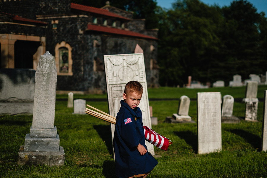 2nd -  General News - 1st place - T.J. Sprowl, 4, hauls a bundle of American Flags across East Lawn Cemetery in Sugarcreek. Cub Scout Pack 91 members were decorating graves ahead of Memorial Day. (Andrew Dolph / The Times Reporter)   (Andrew Dolph / The Times Reporter)