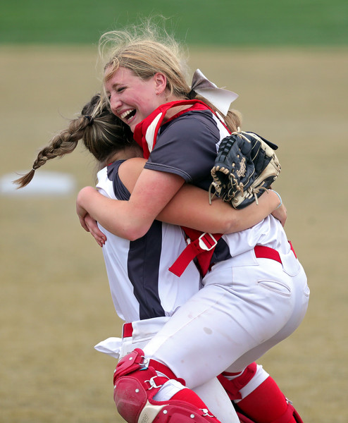 2nd -  Sports Feature - 2nd place - Northwest catcher Lola Bleakley (right) leaps into the arms of Caroline Metzger after beating Coventry, 4-2, in a Div. II district semifinal game in Canton. (Jeff Lange / Akron Beacon Journal)   (Jeff Lange / Akron Beacon Journal)