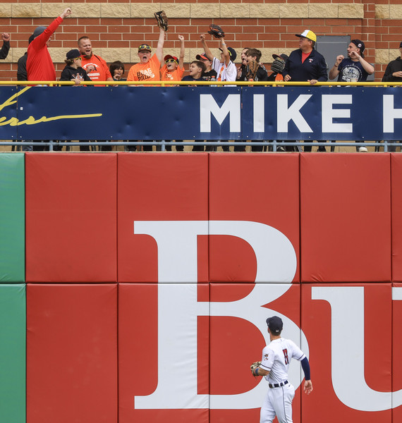 2nd -   - A young fan catches a home run in the stands as Toledo’s Justice Bigbie watches from left field during an International League baseball game at Fifth Third Field in Toledo. (Rebecca Benson / The Blade)   (Rebecca Benson / The Blade)