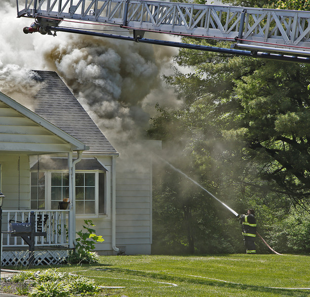 2nd -  Spot News - 3rd place - Members of the Springfield Township Fire Department battled a house fire in the two thousand block of Seminole Avenue in the Sunnyland neighborhood. There were no injuries reported in the fire that was contained to the attic area of the house.  (Bill Lackey / Springfield News-Sun)   (Bill Lackey / Springfield News-Sun)