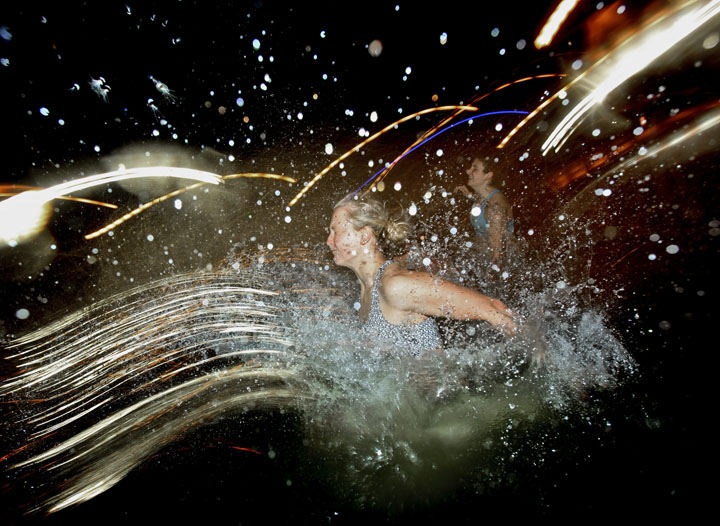 Feature - 3rd place - Nadine Seehaus, an Ohio State Student from Germany, jumps into Mirror Lake Nov. 22, 2011. Officials expect thousands of students to jump into the lake over a four-hour period beginning at 10 p.m. The jump is a tradition leading up to the football game between Ohio State and the University of Michigan. (Eric Albrecht / The Columbus Dispatch)