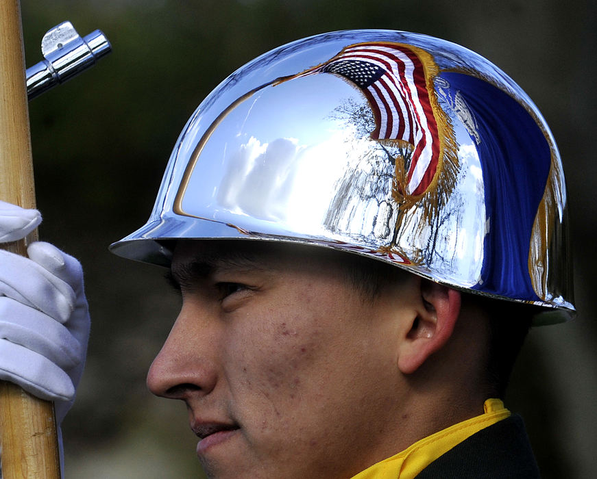 General News - 2nd place - The American flag is reflected in the chrome helmet of a Wright State University R.O.T.C. cadet as he presents the colors during the Veterans Day service at Veterans Park in Springfield.  (Bill Lackey / Springfield News-Sun)