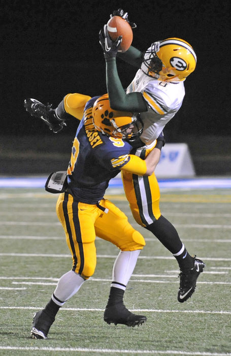 Sports - 1st place - Conor Hennessey of St. Ignatius put a hit on Qunicy Jones of St. Edwards as he makes a catch during the Division I regional semi-finals at Brunswick High School. St. Ignatius won 23-20 on a field goal with 2 seconds left in regulation.  (Kyle Lanzer / Sun Newspapers)