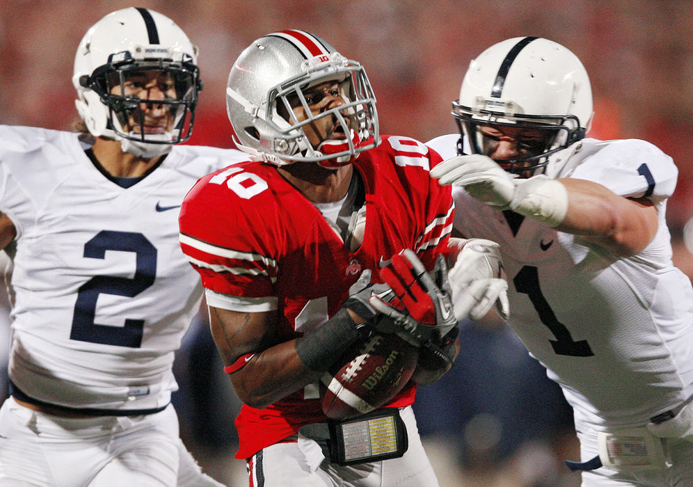 Sports - HM - Ohio State wide receiver Corey Brown (10) has the ball go through his hands on a long pass with Penn State cornerback Chaz Powell (2) and safety Nick Sukay (1) defending on the play. (Kyle Robertson / The Columbus Dispatch)