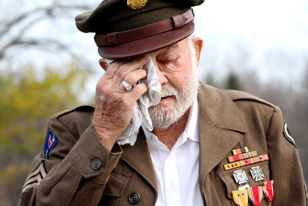 Feature - 2nd placeMorris Finney Jr. wipes away tears as he listens to "God Bless America" at Beachwood Cemetery at 11am, November 11th, 2012. Finney, 89, served in the Army and fought in New Guinea, the Phiippines and Japan during WWII. His uncle, he says, served in Europe while Finney was in the Pacific. His uncle was shot and killed off the Bay of  Biscay.  (Lynn Ischay / The Plain Dealer)