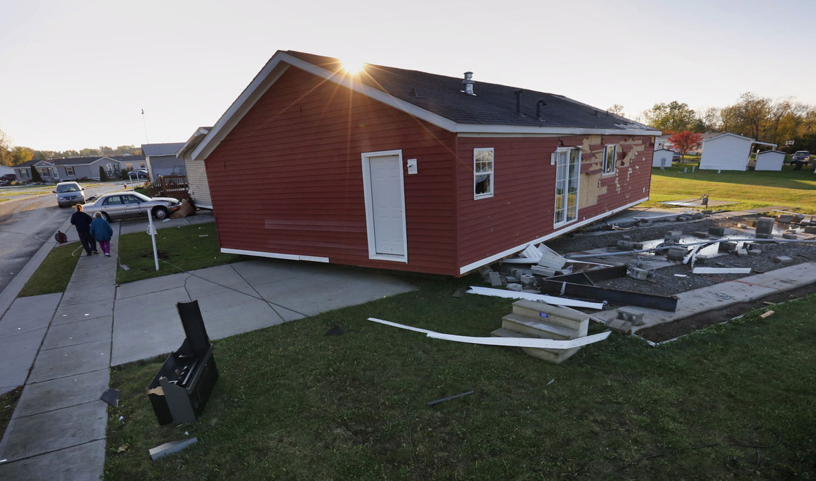 Spot News - 2nd placeThe sun rises behind a unoccupied model home on Berryvile Road in the Shenandoah Commons that was blown off it's foundation during a Halloween night storm. No one was injured. (Tom Dodge / The Columbus Dispatch)