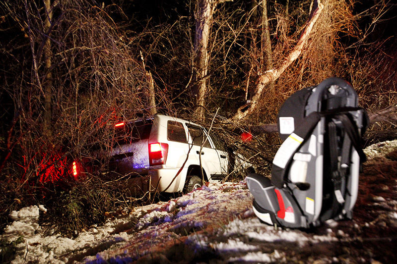 Spot News - 3rd place - A Huron Township man's SUV slid down a shallow ravine on Shawmill Road. Joseph Bores, 58, of the 1800 block of Boos Road was cited with failure to control for the crash.  (Angela Wilhelm / Sandusky Register)