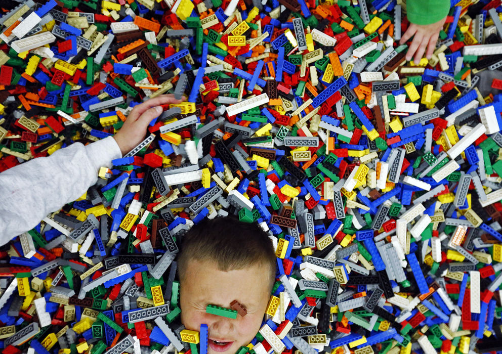 Feature - 3rd place - Brody Eckelbarger, 8, of Sunbury is buried by his sister, Liberty, in a giant pile of LEGOs at the LEGO® Creativity Tour at The Greater Columbus Convention Center. The sold-out tour allowed boys and girls of all ages the opportunity to build, create and enjoy a unique LEGO experience through engaging play areas, construction zones, family-oriented activities and more.  (Leah Klafczynski / The Columbus Dispatch)