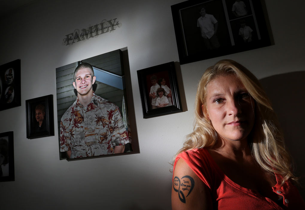 Portrait - 2nd place - Tricia Lawton-Cumer at her Westerville home with a portrait and a tattoo memorializing her son Todd Cumer who committed suicide.  (Eric Albrecht / The Columbus Dispatch)