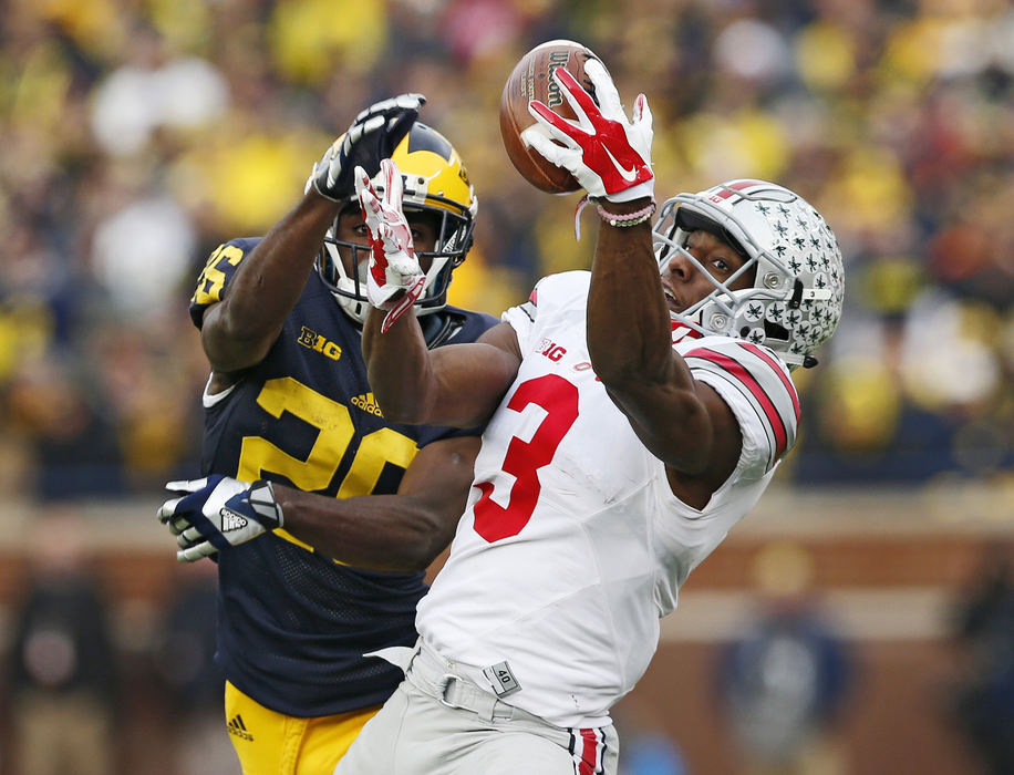 SSports - 1st place - Ohio State  wide receiver Michael Thomas (3) catches a pass behind Michigan cornerback Jourdan Lewis (26) during the fourth quarter at Michigan Stadium in Ann Arbor. (Adam Cairns / The Columbus Dispatch)