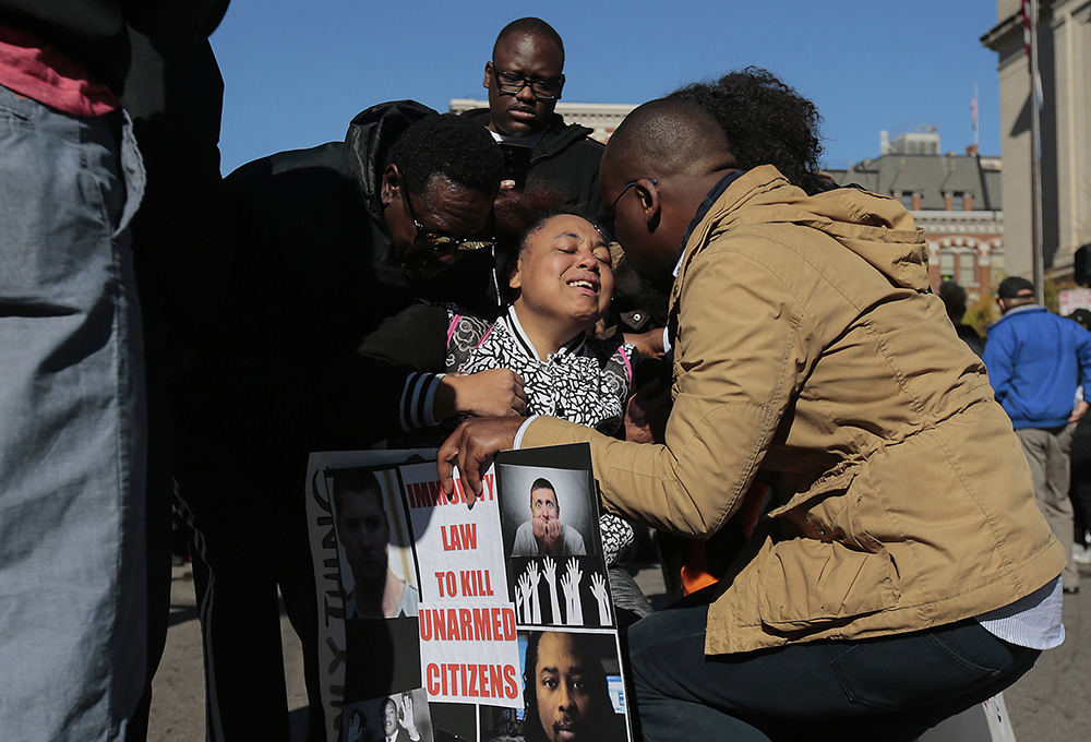 AGeneral News - 1st place - Jashaylia Jenkins, 20 (center) Sam DuBose's cousin, reacts outside the Hamilton County Courthouse after the trial of former University of Cincinnati police officer Ray Tensing was declared a mistrial. Ray Tensing, the former University of Cincinnati police officer, is charged with the murder of Sam DuBose during a routine traffic stop on July 19, 2015. (Kareem Elgazzar / The Cincinnati Enquirer)