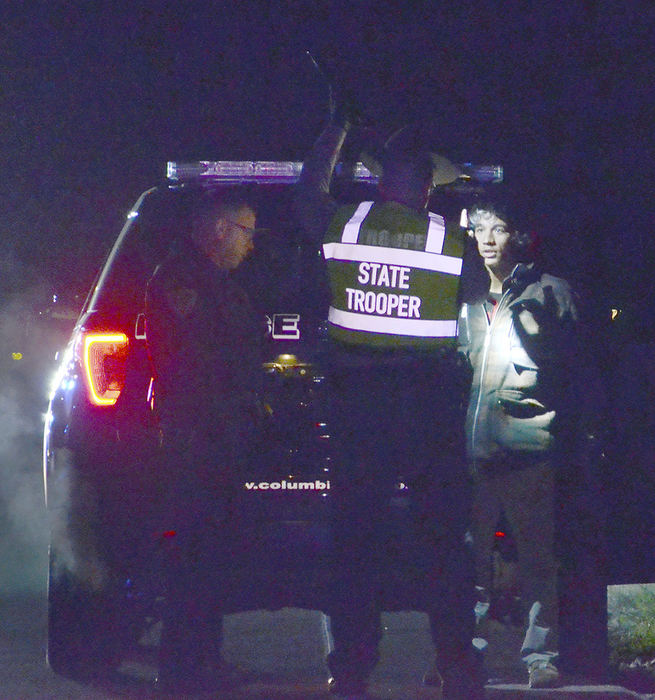 Spot News - 3rd place - Trooper Jared Paine administers a field sobriety test checking Benjamin Armstead’s eyes following a high-speed chase and resulting crash. Columbiana Patrolman Mark Edwards observes the field sobriety test. Armstead was believed to not be under the influence, followingthe test. (Patricia Schaeffer / The (Lisbon) Morning Journal)