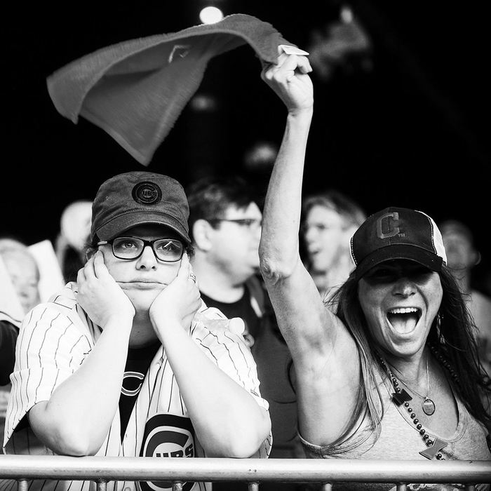 Story - 3rd place - Teresa Martina of Columbus (right) cheers next to a distressed Cubs fan (left) after the Cleveland Indians tie World Series Game 7 against Chicago in the eighth inning. (Leah Klafczynski / Akron Beacon Journal)