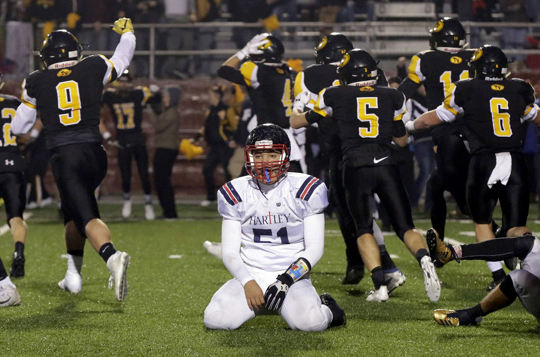 SPSports Feature - 2nd place - Hartley's Nate Jackson sits in disbelief as Dresden Tri-Valley players celebrate a 13-9 Division III regional final victory at White Field in Newark. (Shane Flanigan / ThisWeek Community News)