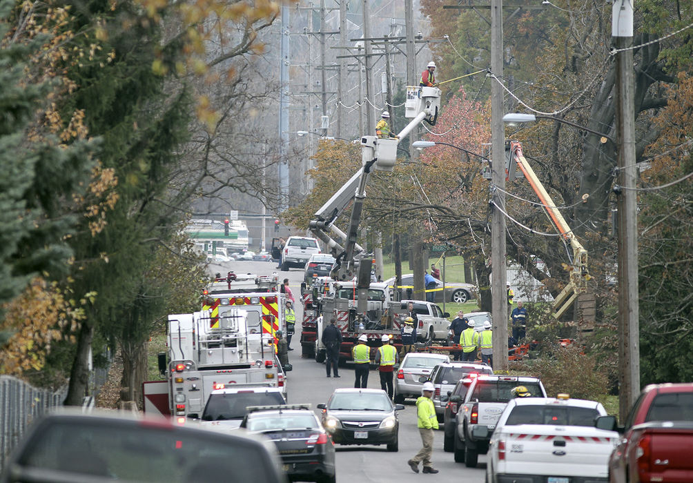 Sports Feature - 3rd place - Firefighters respond to an electrocution at 1772 Coventry Street on  in Akron. A New Franklin man was declared dead on the scene when the bucket lift he was using to trim trees for a homeowner made contact with a 23 kilo-volt power line. (Leah Klafczynski / Akron Beacon Journal)