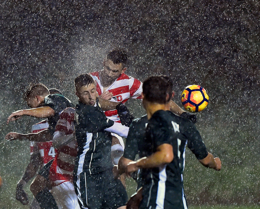 Sports - 1st place - Dayton's Nick Hagenkord battles for a ball against George Mason during a heavy downpour at Baujan Field in Dayton. The Dayton Flyers defeated Mason 5-2 (Erik Schelkun / Elsestar Images)