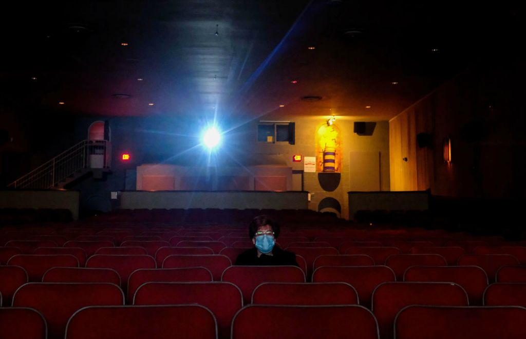 Feature - 1st place - Maumee resident Elizabeth McCartney has the 5 p.m. showing of the 1971 film "Willy Wonka & the Chocolate Factory" all to herself at the Maumee Indoor Theatre. Kurt Steiss / The Blade