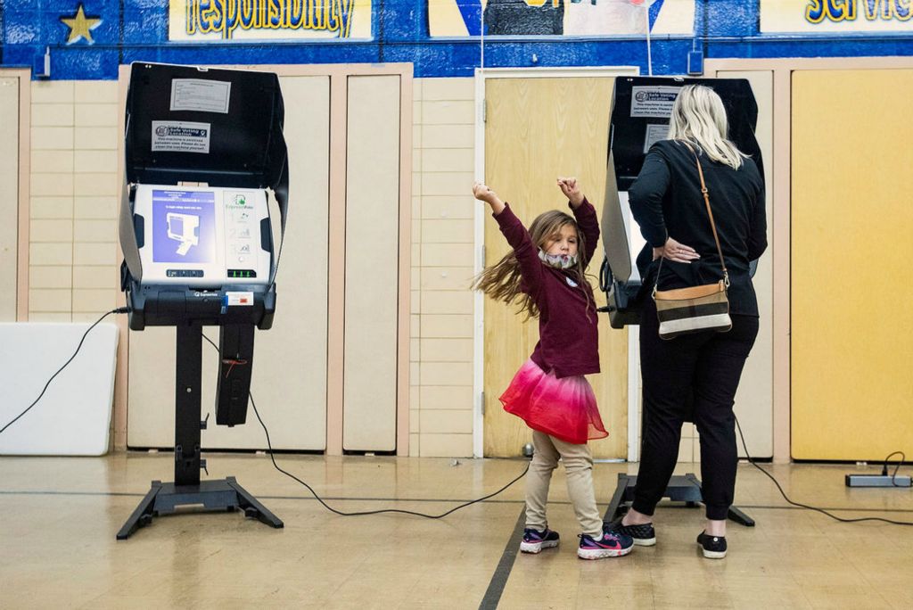 Feature - 3rd place - Annalise Ramirez, 5, dances as she waits for her mom Amanda to finish voting at Washington Local Schools Administration Building in Toledo. Rebecca Benson / The Blade