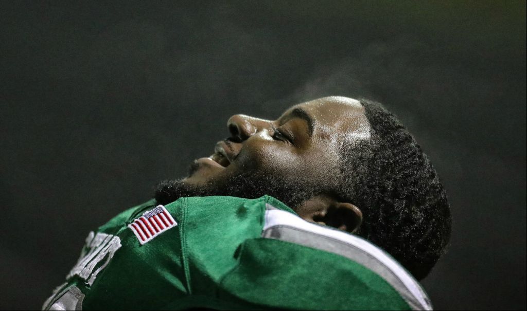 Sports Feature - 1st place - Steam comes off Start lineman Marcus Ensley while he sits on the bench during the City League Championship football game against Woodward in Toledo. Start defeated Woodward, 20-14, in overtime.  Jeremy Wadsworth / The Blade