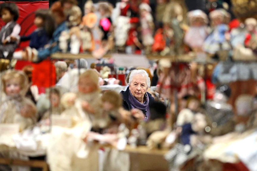 Feature - 3rd place - Howell, Michigan resident Vianne Bowman is framed by a display of dolls as she looks around during the Toledo Doll & Bear Show & Sale hosted at the Lucas County Recreation Center in Maumee, Ohio. (Kurt Steiss / The Blade)