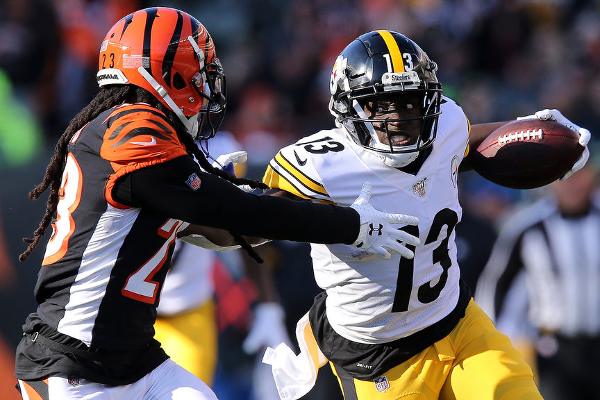 Sports - 1st place - Pittsburgh Steelers wide receiver James Washington (13) stiff arms Cincinnati Bengals cornerback B.W. Webb (23) on a touchdown catch in the third quarter of a game  at Paul Brown Stadium in Cincinnati. The Pittsburgh Steelers won 16-10, and the Bengals fell to 0-11 on the season.  (Kareem Elgazzar / The Cincinnati Enquirer)