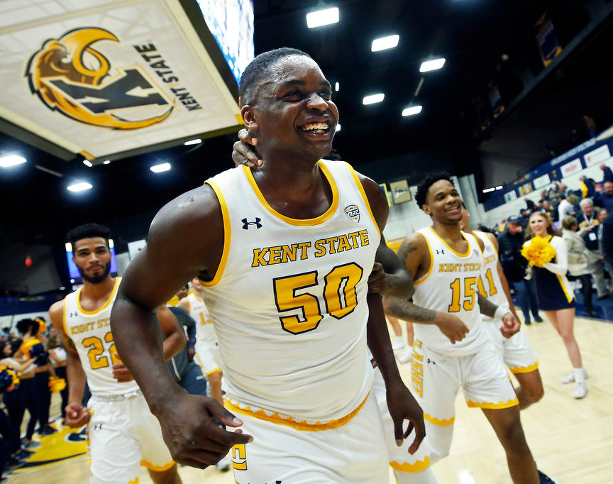 Story - 2nd place - Kent State freshman center Kalin Bennett, the first NCAA Division I athlete with autism, rushes off the court with teammates to ring the victory bell after the Flashes defeated the Hiram College Terriers, 97-58, in their season opener at the MAC Center in Kent. (Jeff Lange / Akron Beacon Journal)