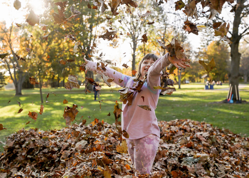 Feature - 2nd place - Clara Schwarzkopf, 6, throws leaves in the air as she and other children play in a pile of leaves on an unseasonably warm day at the Toledo Botanical Garden.(Kurt Steiss / The Blade)