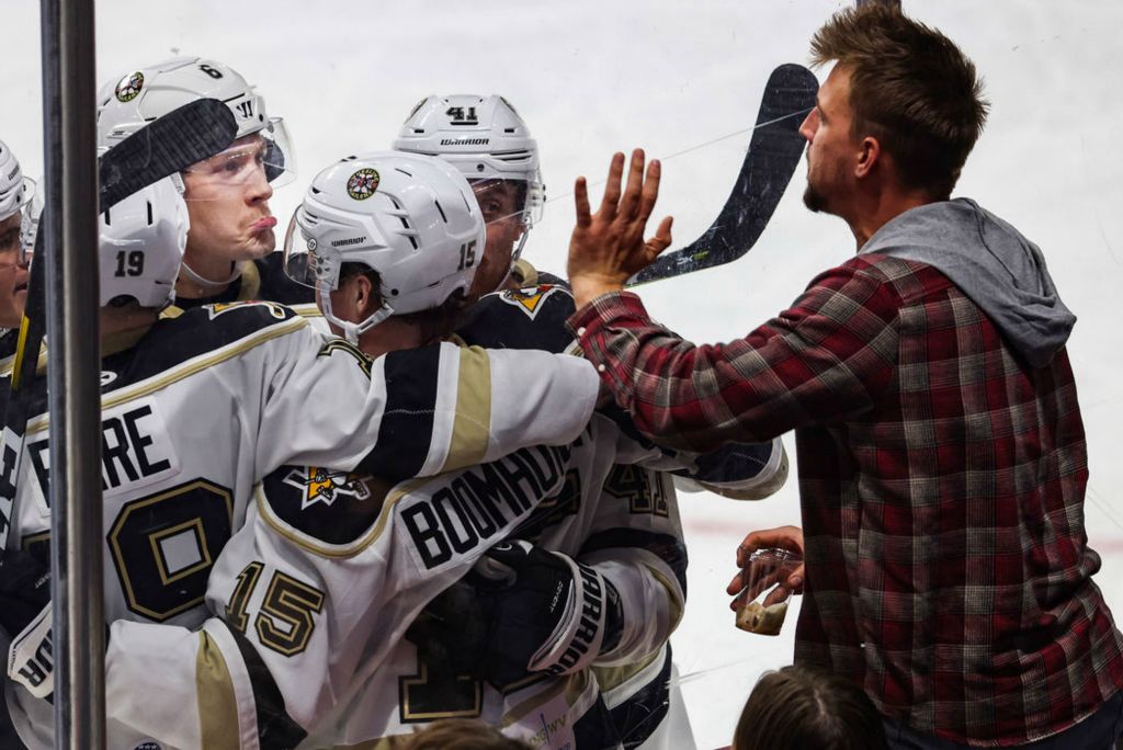 Sports Feature - 1st place - Wheeling’s team mocks a Walleye fan after scoring their third goal during the second period an ECHL game at the Huntington Center in downtown Toledo.(Rebecca Benson / The Blade)