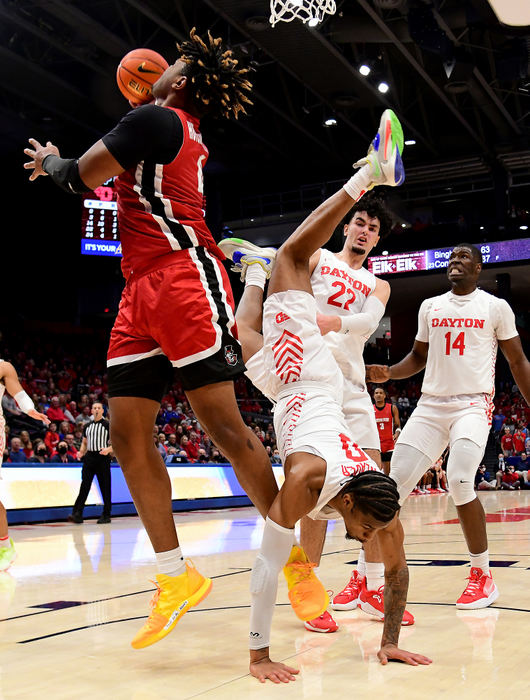 Sports - 1st place - Dayton's Elijah Weaver gets flipped into a handstand as Austin Peay’s Elijah Hutchins-Everett attempts a shot. Austin Peay defeated Dayton 87-81 at UD Arena.(Erik Schelkun / Elsestar Images)