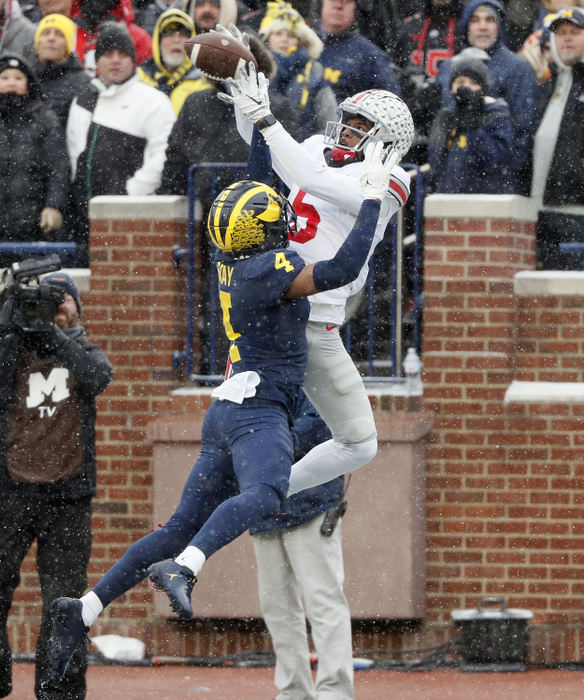 Sports - 2nd place - Ohio State wide receiver Garrett Wilson (5) makes a touchdown catch against Michigan defensive back Vincent Gray (4) during the second quarter of their game at Michigan Stadium at Ann Arbor, Michigan.(Kyle Robertson / The Columbus Dispatch)