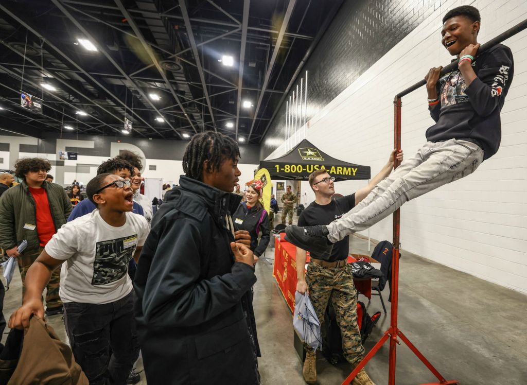 General News - 1st place - Ta’Ron Williams, an eighth grader at Sherman Elementary School, does pulls ups at the Marines exhibit during Toledo Public Schools’ annual Career Connect Expo at the Glass City Center in Toledo.  (Jeremy Wadsworth / The Blade)