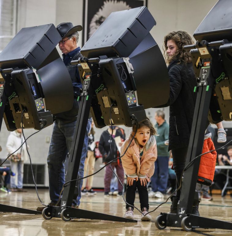 General News - 2nd place - Maxine Berry, 5, yawns as her mother Kim Berry votes at Fassett Junior High School in Oregon.  (Jeremy Wadsworth / The Blade)