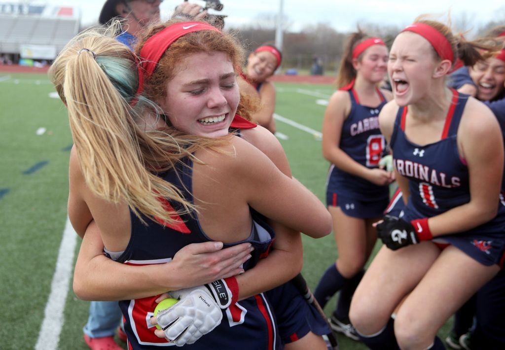 Sports Feature - 3rd place - Thomas Worthington's Sophia Borghese (second from left) and Clara Scott (left) celebrate with teammates after a 3-2 overtime win against Watterson in the OHSAA state field hockey championship game at Thomas Worthington High School.  (Shane Flanigan / ThisWeek Community News)