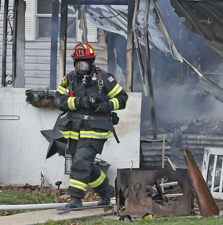 Spot News - 3rd place - A Mad River Township firefighter carries a chihuahua out of a burning mobile home at the Pleasant Valley Estates Mobile Home Park. Two small dogs were rescued from the fire. The owners were not home at the time of the blaze, which started on the porch and spread to the mobile home. There were no injuries in the blaze but the home suffered extensive damage.  (Bill Lackey / Springfield News-Sun)