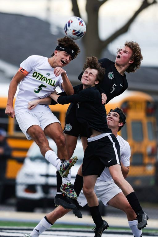 Sports - 1st place - Ottoville’s Kellen Schlagbaum (left) and Ottawa Hills’ Liam Silk (center) and Harley Talbott head the ball during the Division III soccer regional final in Tiffin. Ottawa Hills defeated Ottoville, 2-1. (Rebecca Benson / The Blade)